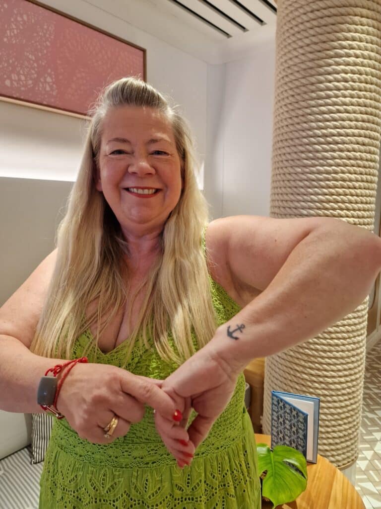 travel franchise franchisee Gaynor showing off tattoo